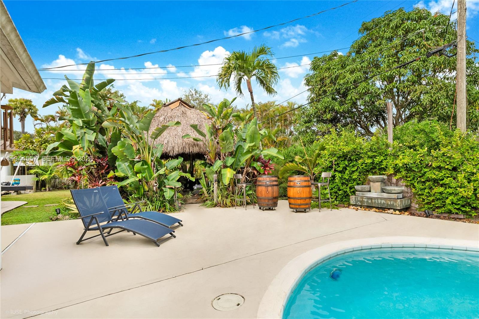 8265 Southwest 119th Street Miami, FL 33156 - Photo 24 of 34 a view of a swimming pool with a lounge chair and potted plants