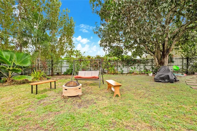 a view of a swimming pool with a patio and a yard