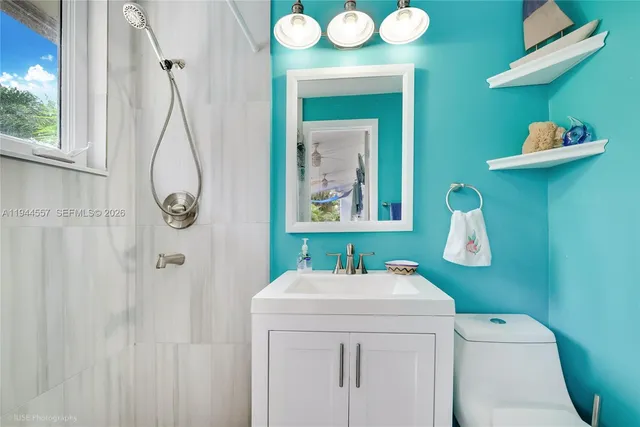a bathroom with a sink a toilet and mirror