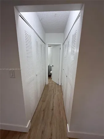 a bathroom with a sink a toilet a mirror and shower