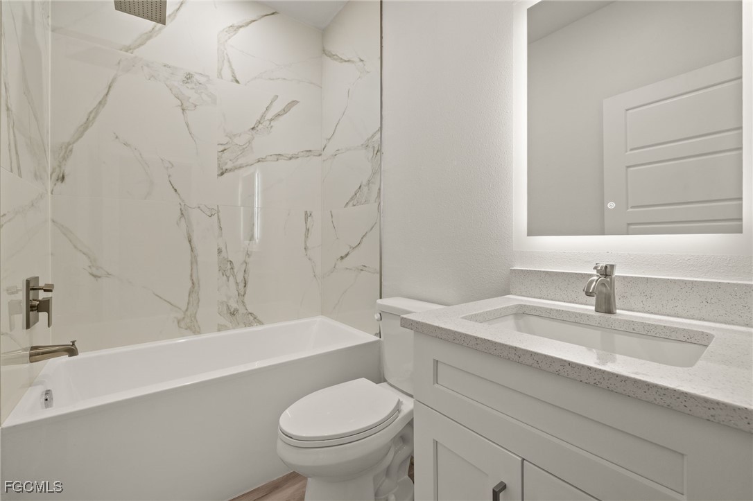 14985 Sunset Eve Loop Fort Myers, FL 33919 - Photo 14 of 18 a bathroom with a sink and a toilet