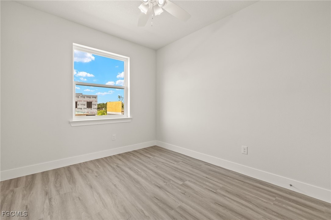 14985 Sunset Eve Loop Fort Myers, FL 33919 - Photo 15 of 18 wooden floor in an empty room