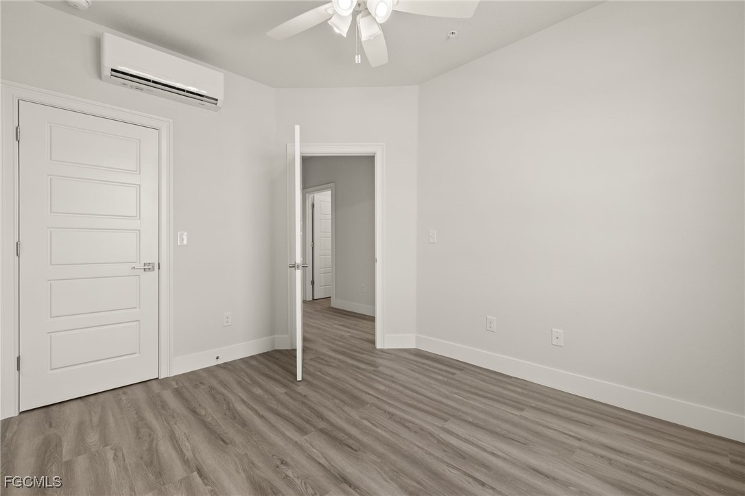 14985 Sunset Eve Loop Fort Myers, FL 33919 - Photo 16 of 18 a view of an empty room with wooden floor