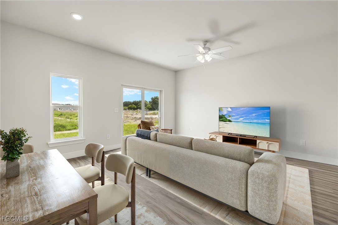 14985 Sunset Eve Loop Fort Myers, FL 33919 - Photo 4 of 18 a living room with furniture and a large window
