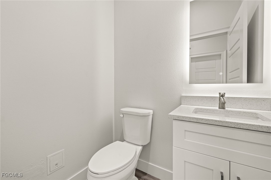 14985 Sunset Eve Loop Fort Myers, FL 33919 - Photo 8 of 18 a white toilet sitting next to a bathroom sink