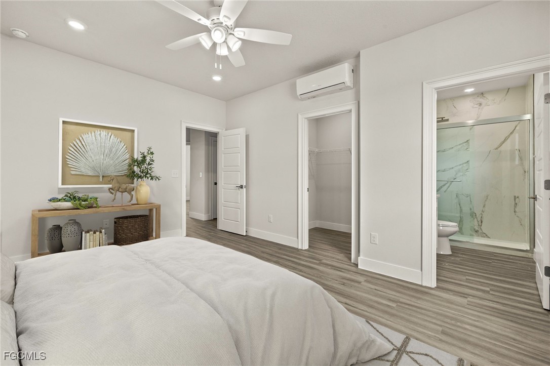 14985 Sunset Eve Loop Fort Myers, FL 33919 - Photo 10 of 18 a bedroom with a bed and a chandelier