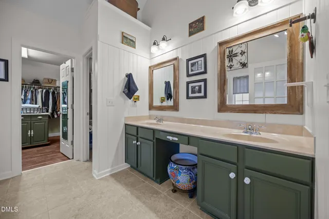 a living room with furniture and paintings on the wall