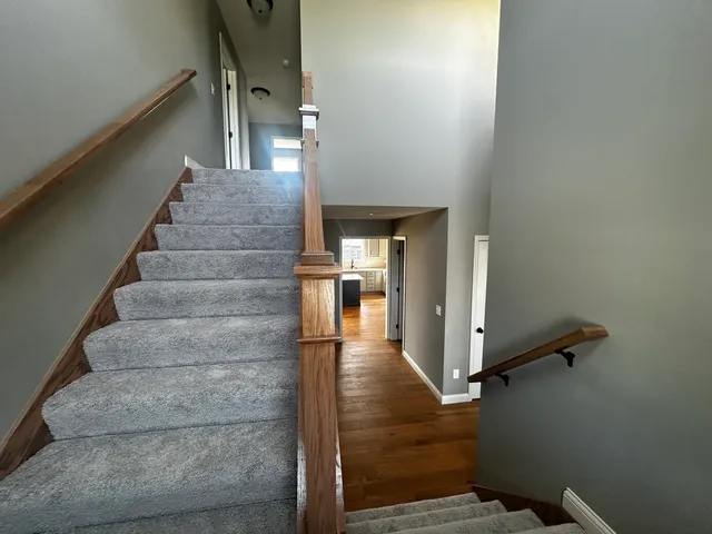 a view of entryway and hall with wooden floor