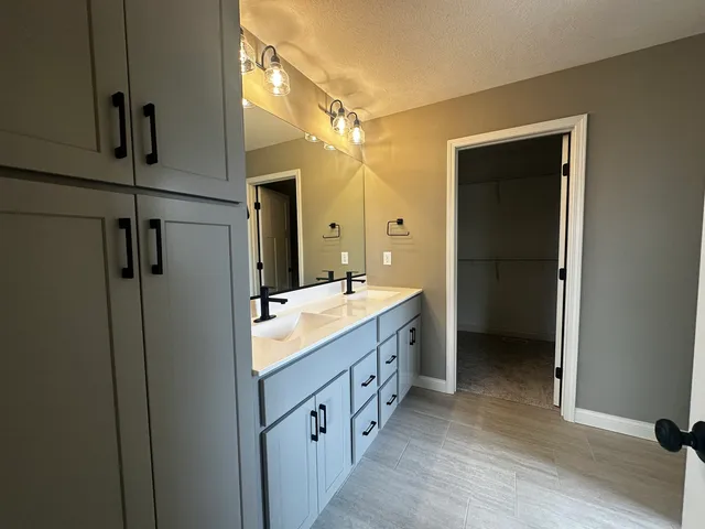 a bathroom with a glass shower door