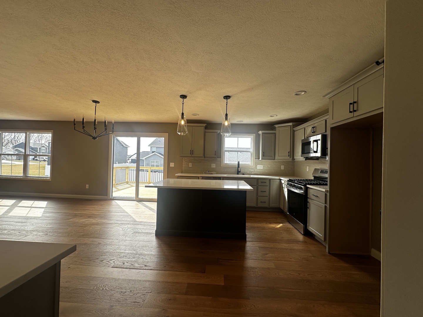 2511 Savanna Road Bloomington, IL 61705 - Photo 4 of 18 a large kitchen with cabinets wooden floor and stainless steel appliances