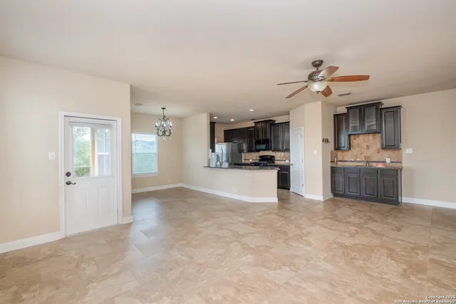 a view of a kitchen with a sink stainless steel appliances and cabinets