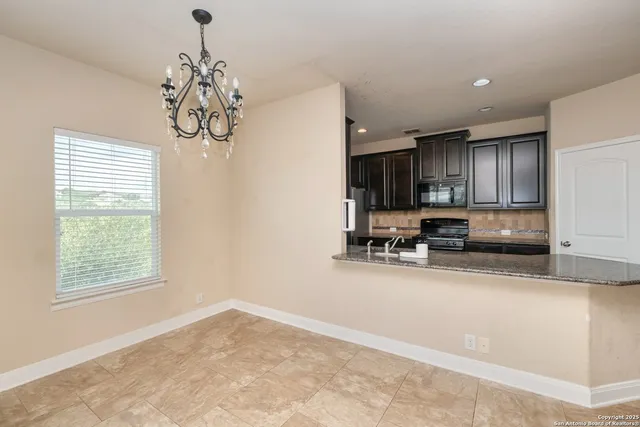 a kitchen with granite countertop a sink stainless steel appliances and cabinets