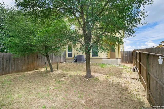 an aerial view of a house with a garden and swimming pool