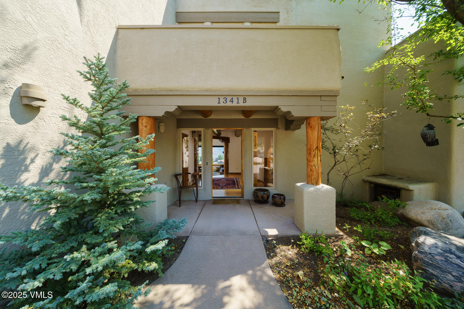 a view of a patio with table and chairs and potted plants