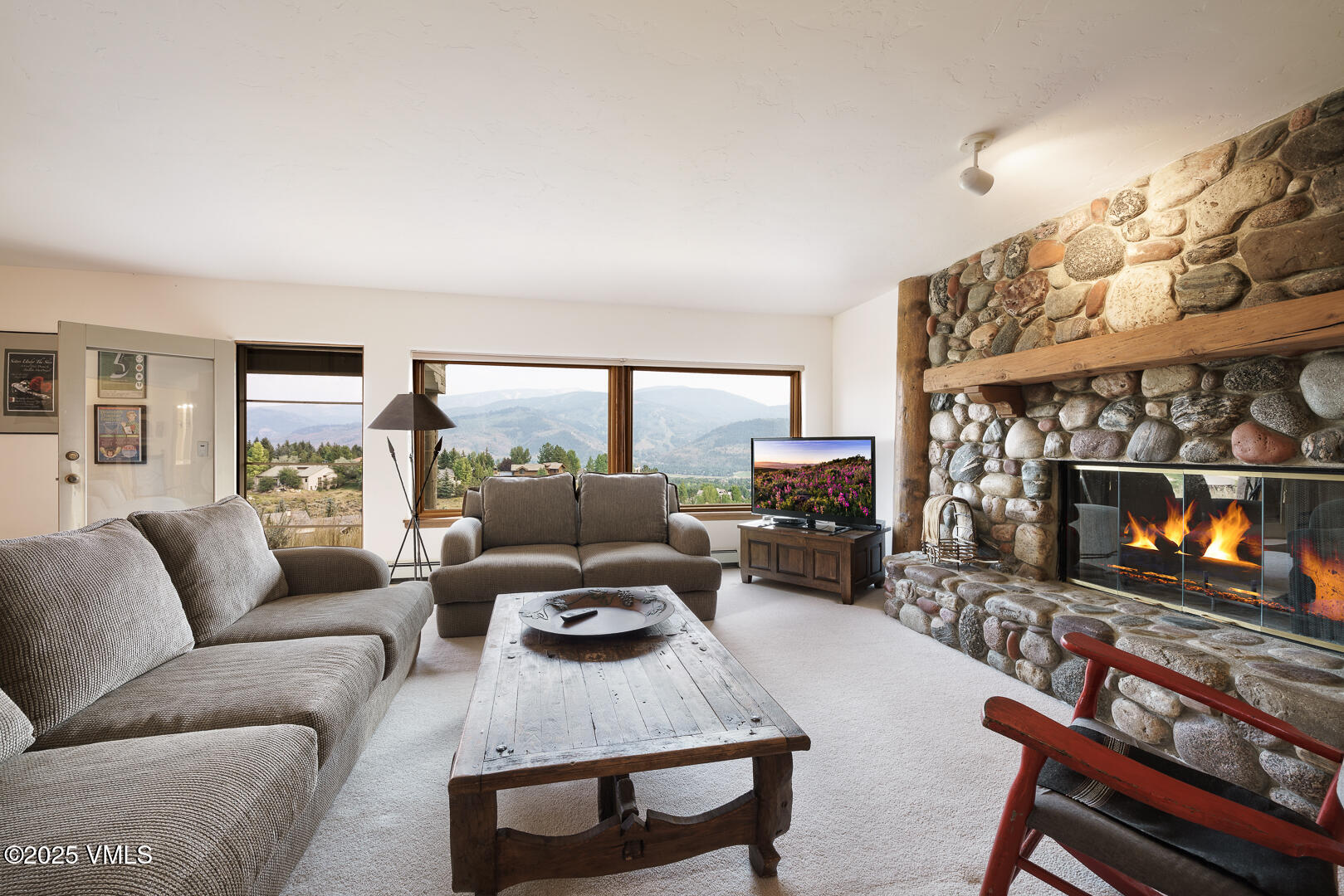 1341 Winslow Road, Unit B Edwards, CO 81632 - Photo 25 of 56 a living room with furniture a fireplace and a flat screen tv