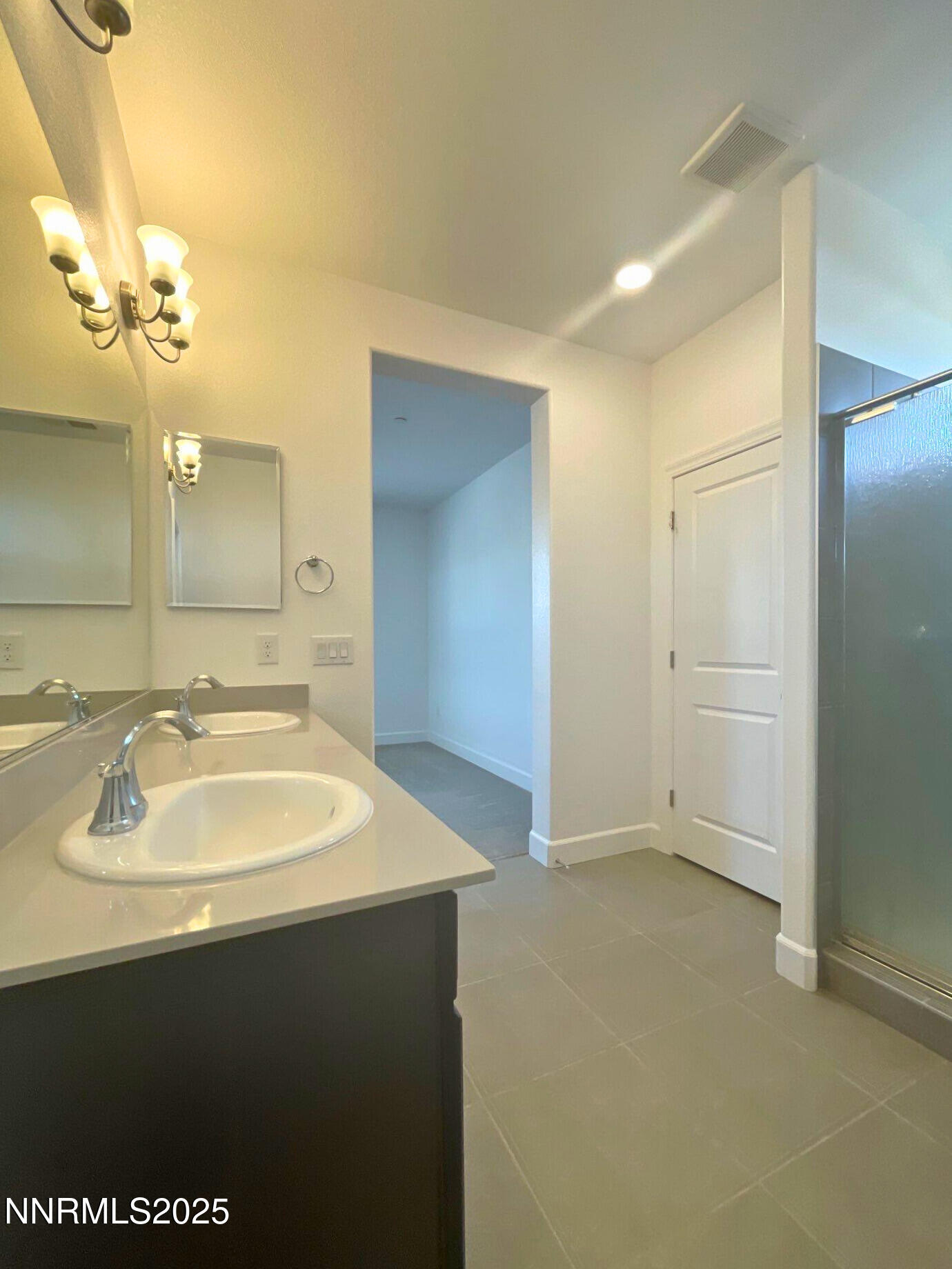 2018 Cradle Mountain Drive, Unit 1 Reno, NV 89523 - Photo 11 of 15 a bathroom with a sink a mirror and a shower