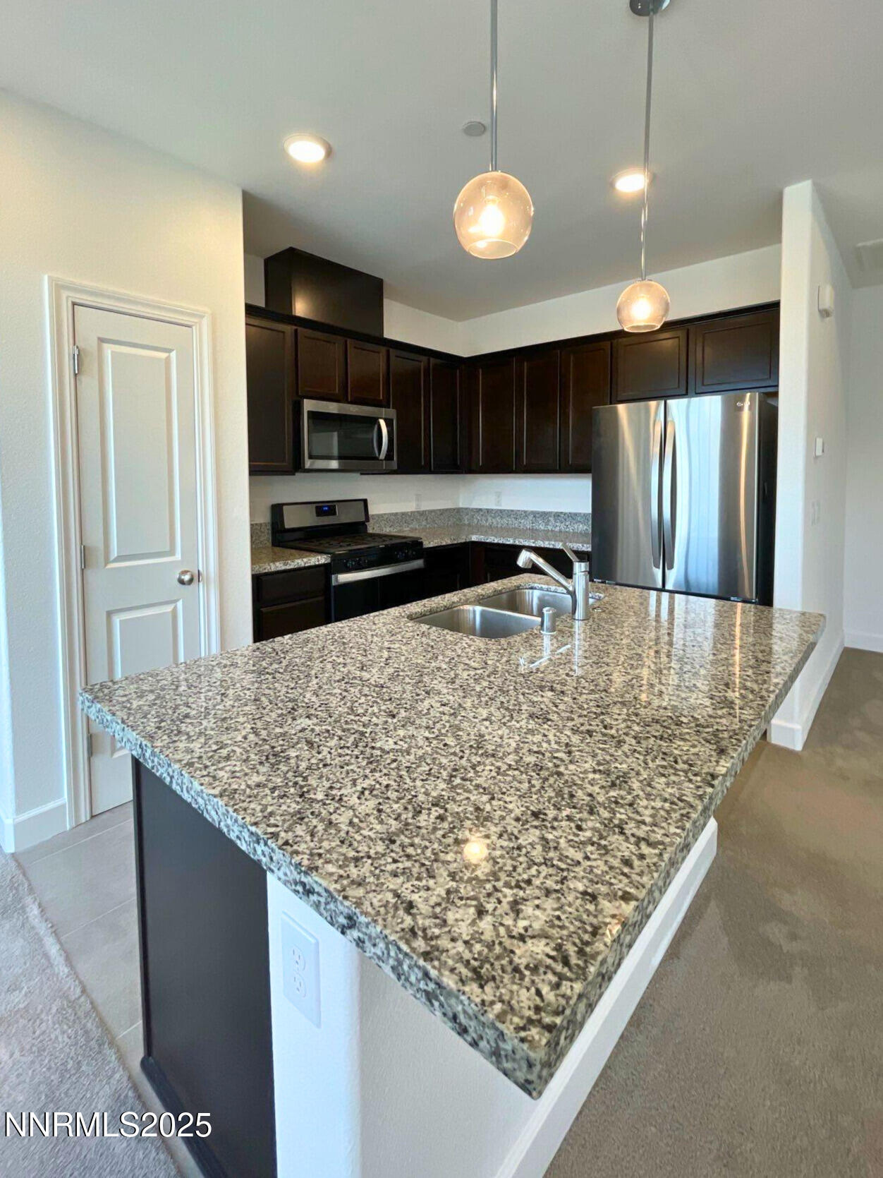2018 Cradle Mountain Drive, Unit 1 Reno, NV 89523 - Photo 2 of 15 a kitchen with stainless steel appliances granite countertop a sink refrigerator and microwave