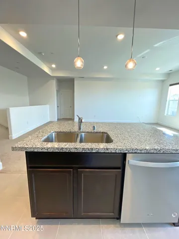 a kitchen with a sink a counter space and appliances