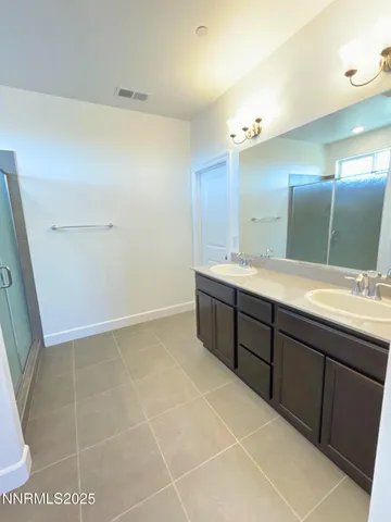 a bathroom with a sink a mirror and a shower