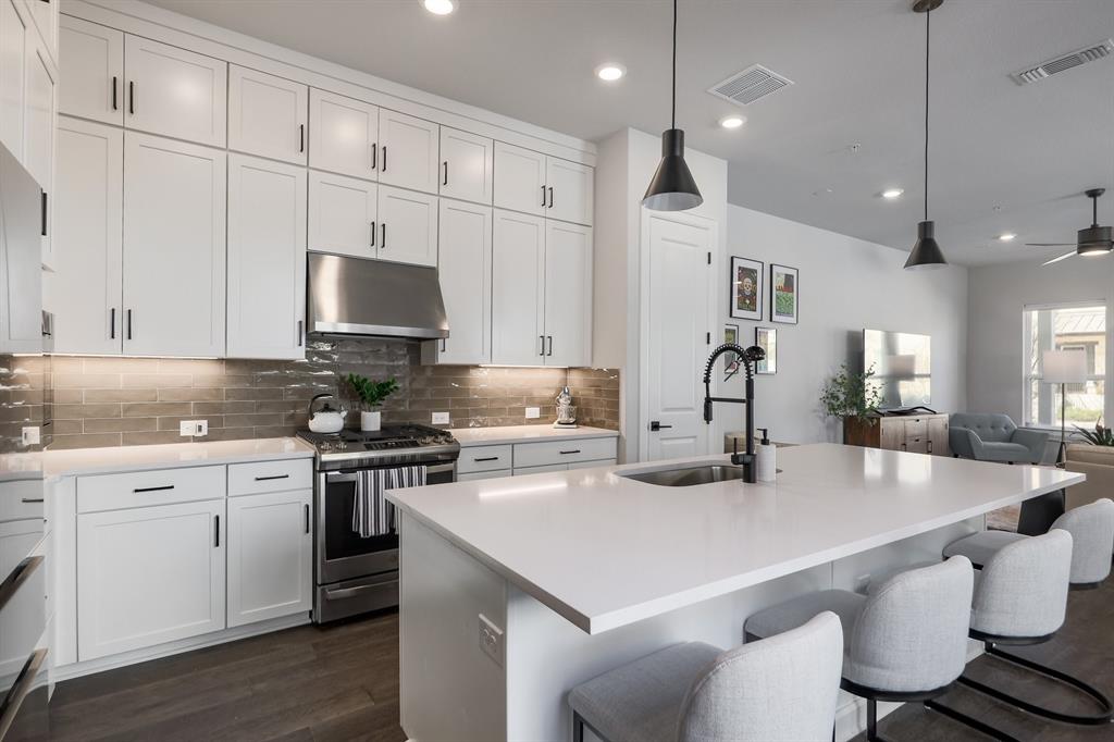 3907 Tilley Street Austin, TX 78723 - Photo 6 of 26 a kitchen with a white cabinets a sink and stainless steel appliances