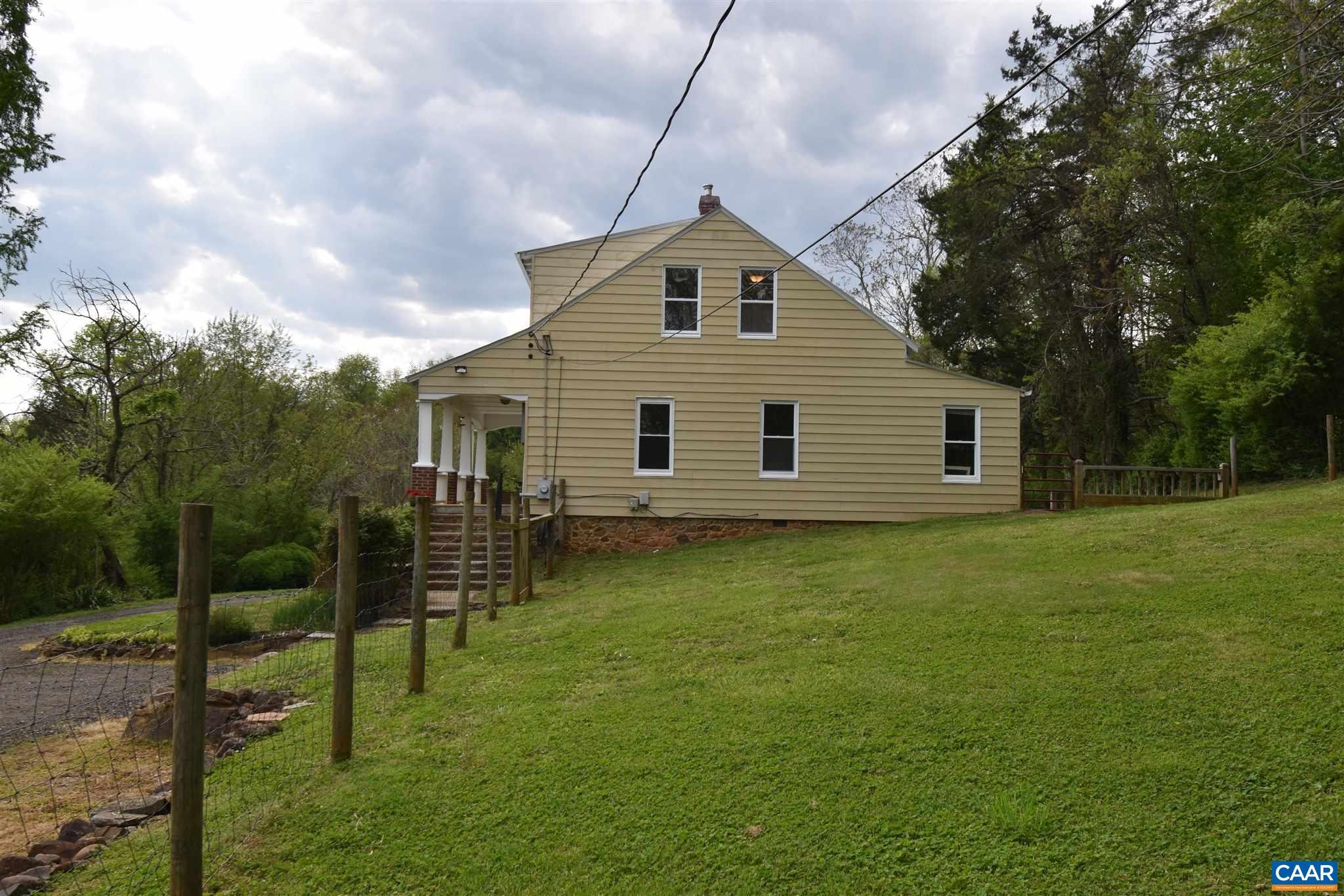 115 Madison Road Stanardsville, VA 22973 - Photo 6 of 49 a backyard of a house with plants and large tree