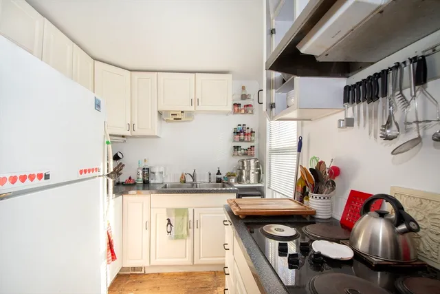 a kitchen with stainless steel appliances cabinets a sink and a refrigerator