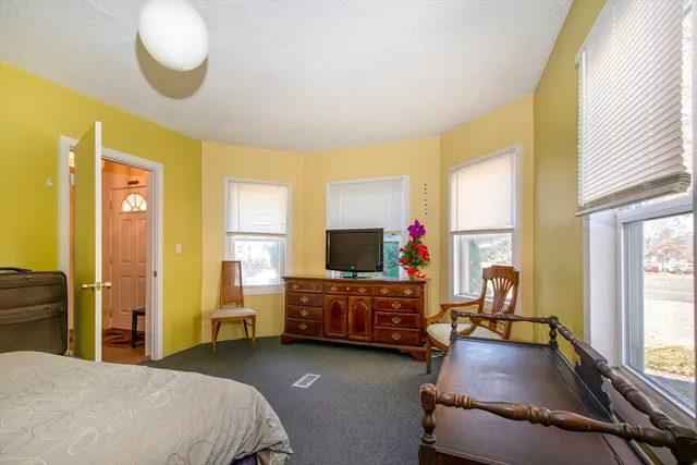 a bedroom with furniture and a flat screen tv