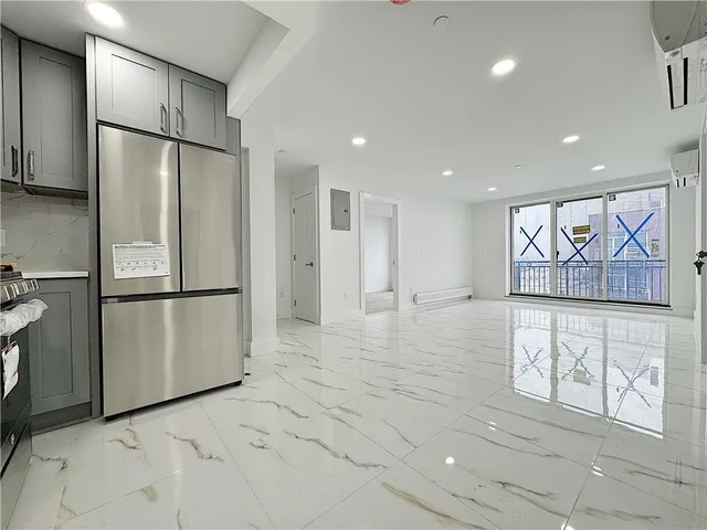 a view of kitchen with furniture and refrigerator