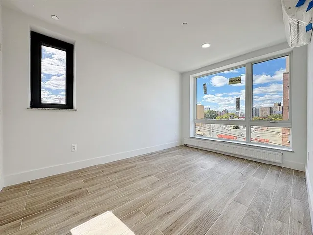 a view of room with window and wooden floor