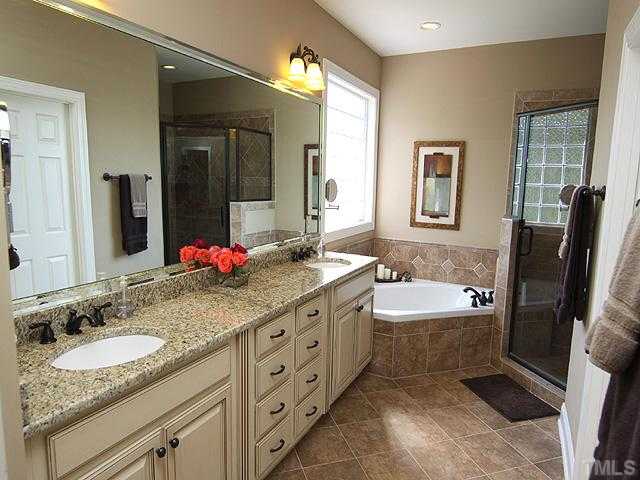 2604 Sunbriar Lane Raleigh, NC 27613 - Photo 15 of 25 A warm soothing retreat after a hard day at the office...relax in the tub or the large shower with bench. Watch your favorite TV morning shows ...wired for cable TV
