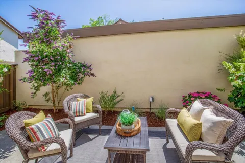 a outdoor living room with furniture and flowers