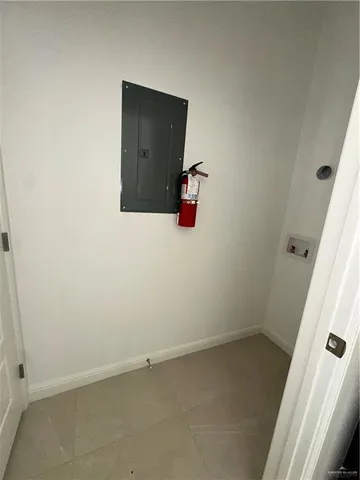 an empty room with wooden door and windows