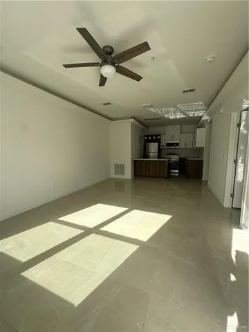 a view of a livingroom with a ceiling fan and window