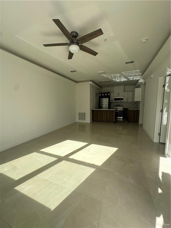 901 Yuma Avenue, Unit 202 McAllen, TX 78503 - Photo 4 of 11 a view of a livingroom with a ceiling fan and window