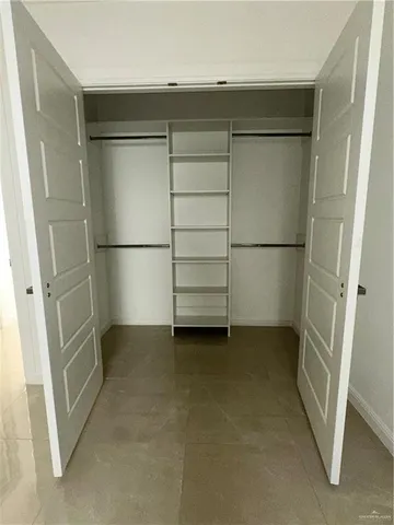 a view of a room with an empty walk in closet