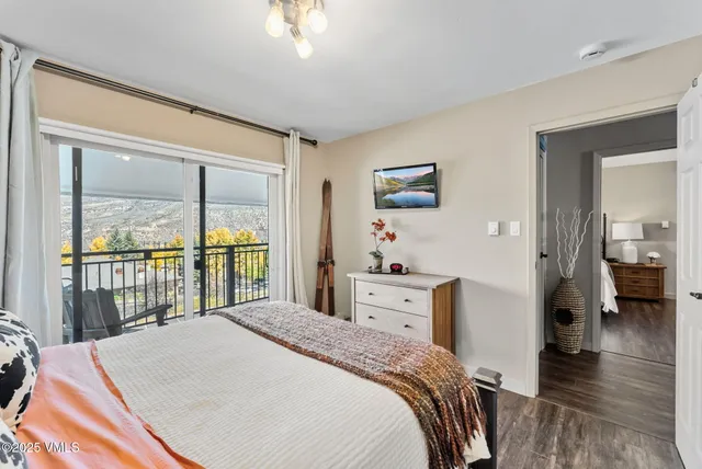 a bedroom with a bed and a large window