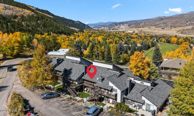 an aerial view of residential houses with outdoor space