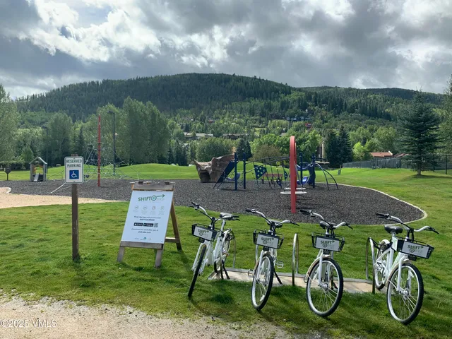 a view of a table and chairs in the garden
