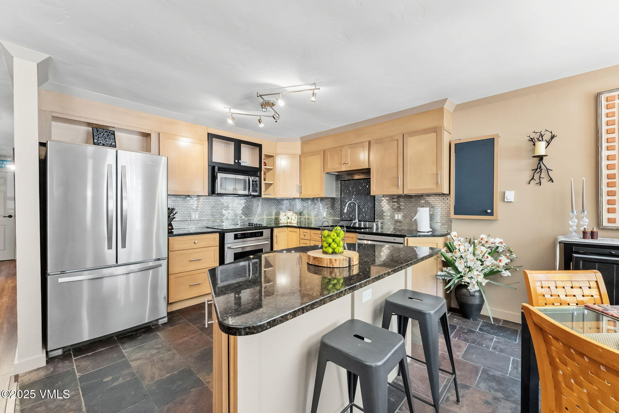 596 Daisy Lane, Unit 10 Avon, CO 81620 - Photo 3 of 34 a kitchen with stainless steel appliances granite countertop a refrigerator and a stove