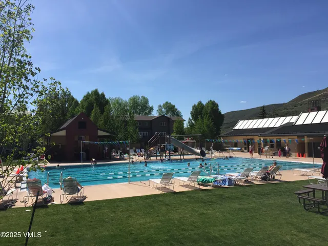 a view of a house with swimming pool and yard