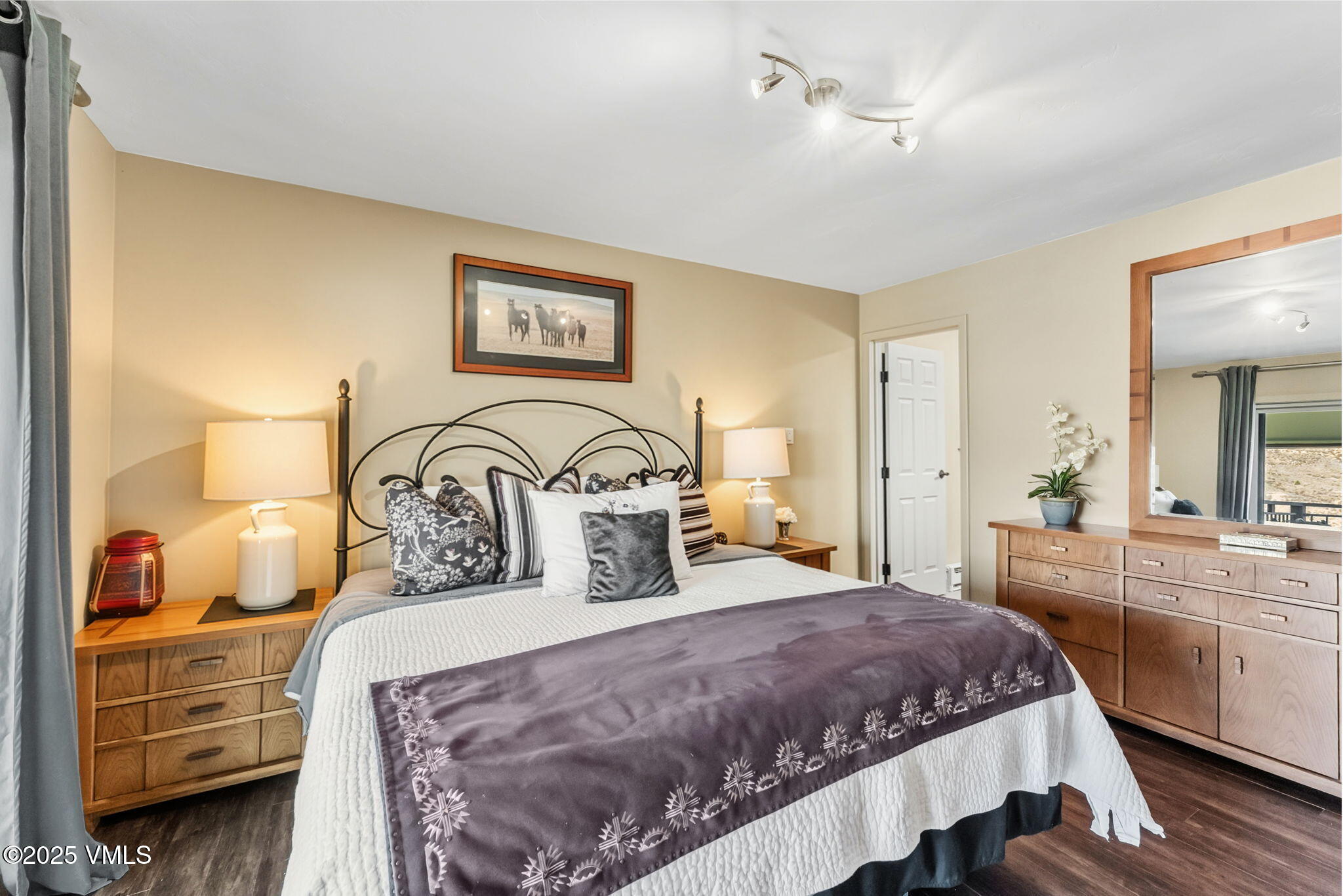 596 Daisy Lane, Unit 10 Avon, CO 81620 - Photo 8 of 34 a bedroom with a large bed and a chandelier