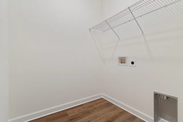 a view of a room with wooden floor