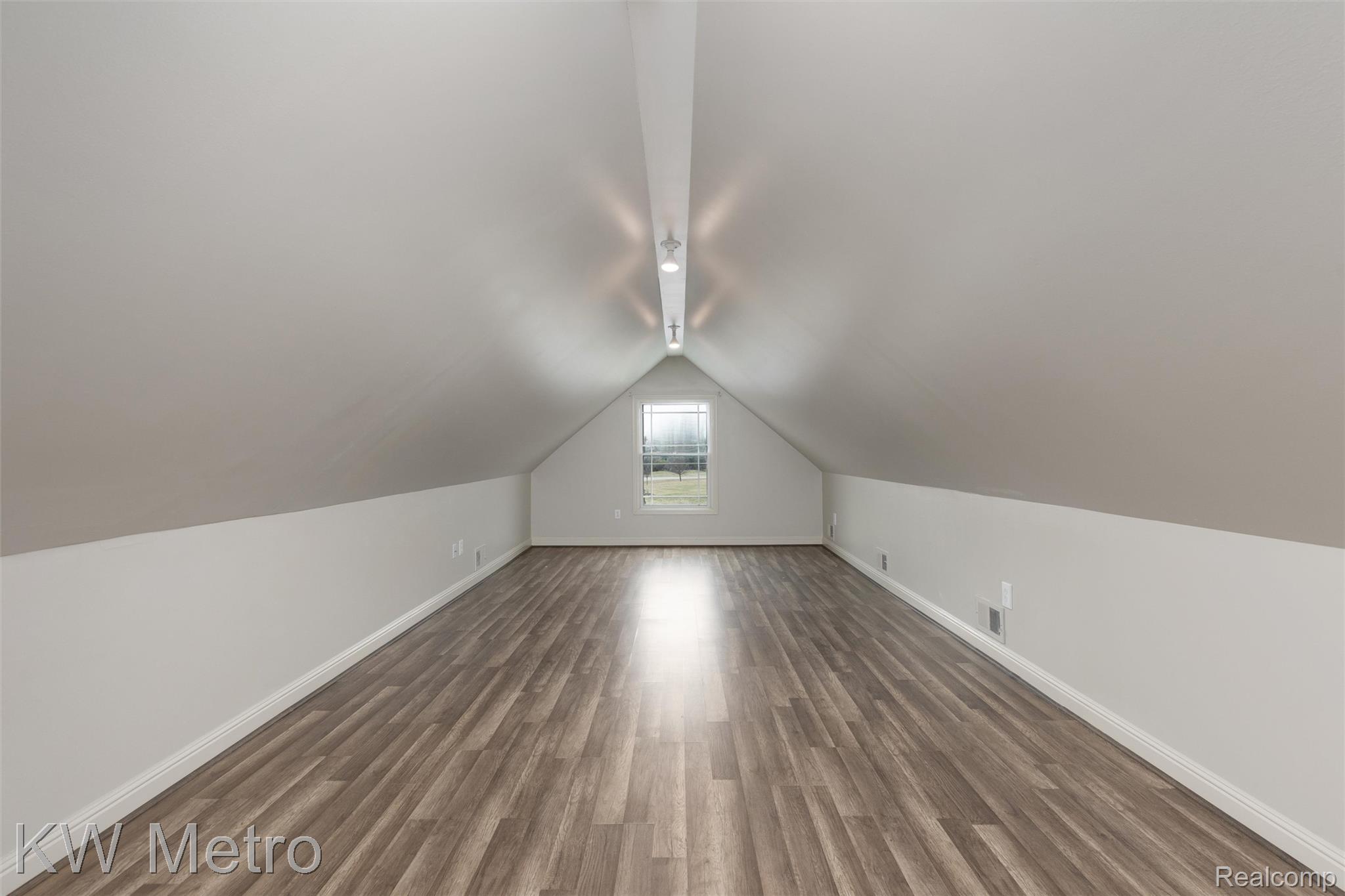 65884 Windrose Court Ray, MI 48096 - Photo 73 of 82 Additional living space with baseboards and dark wood-style floors