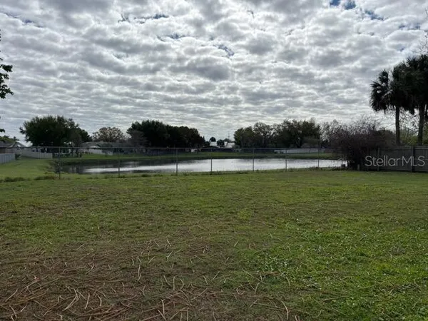 a view of a lake with houses in the back