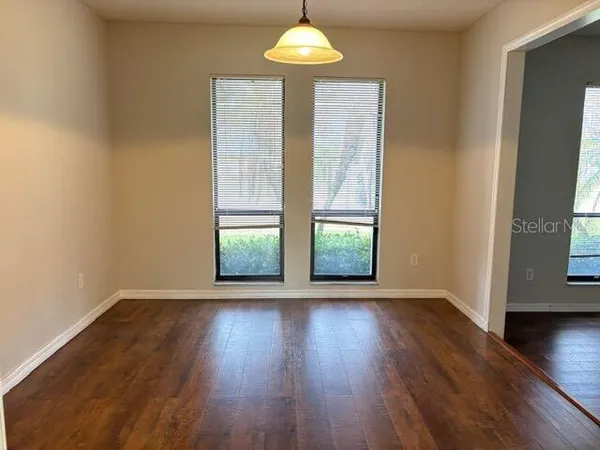 a living room with window and a fireplace