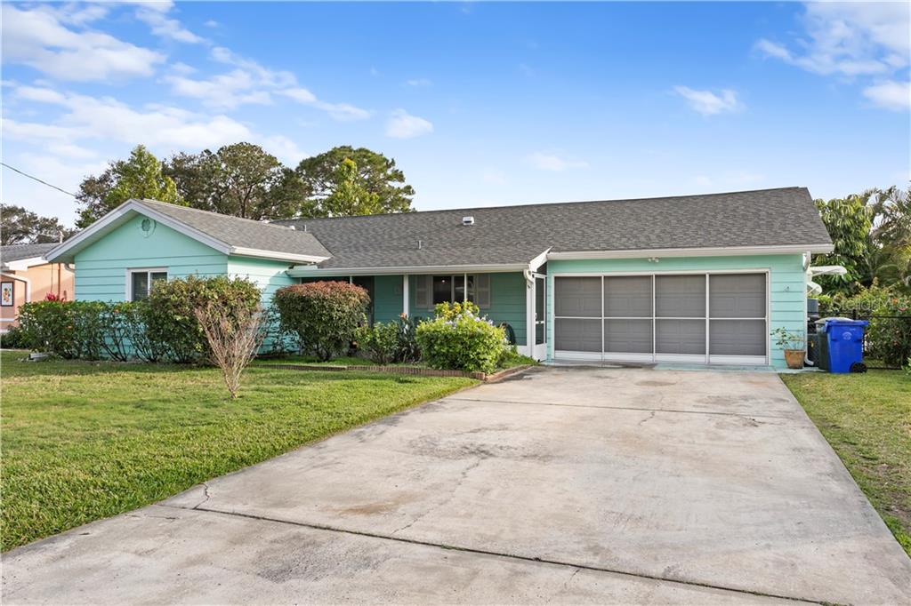791 Terrace Road Dunedin, FL 34698 - Photo 1 of 1 a front view of a house with a garden and yard