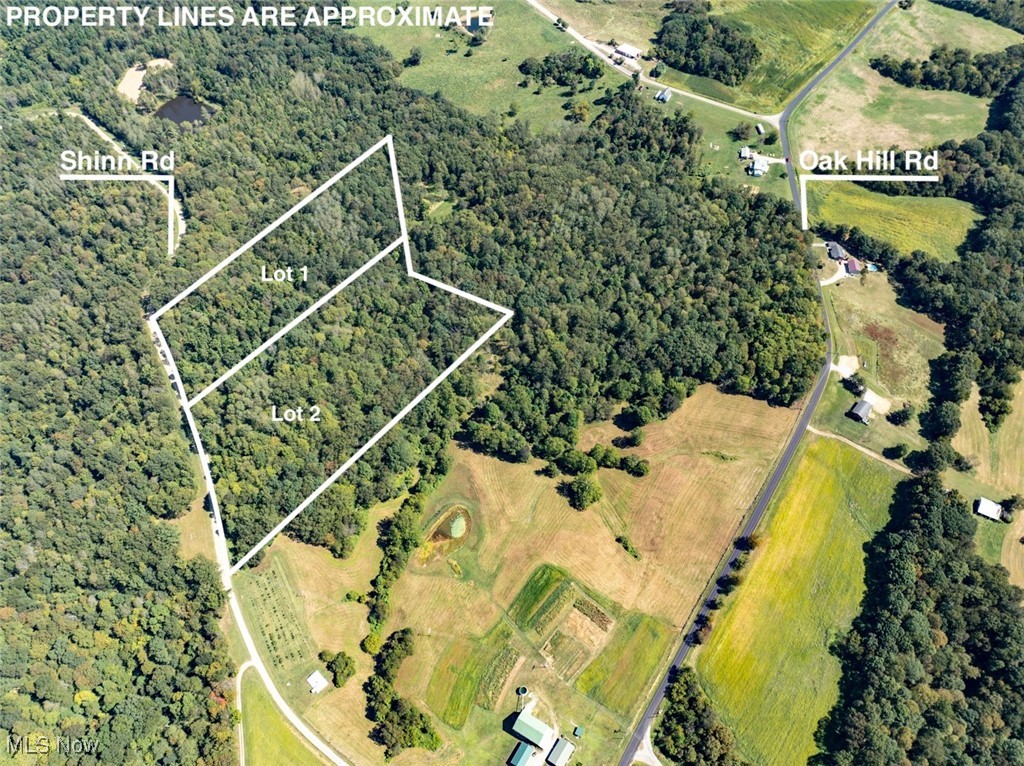 View of property location with property parcel outlined and a heavily wooded area