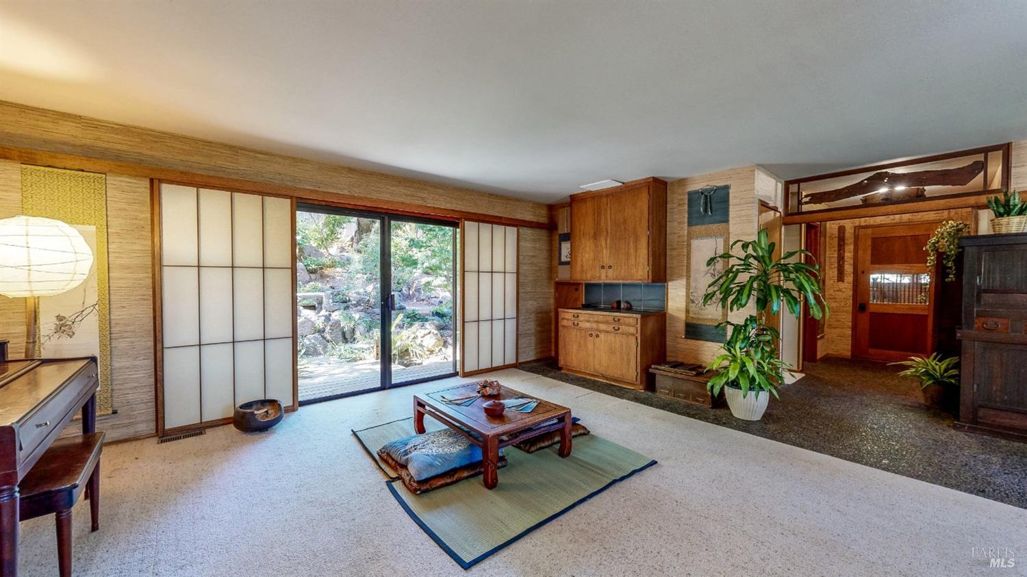 Living room and formal entry on main level looking from bedroom hallway.