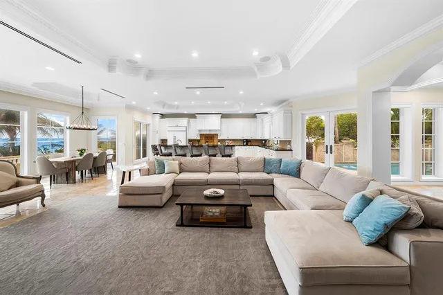 a kitchen with stainless steel appliances granite countertop table chairs sink and cabinets