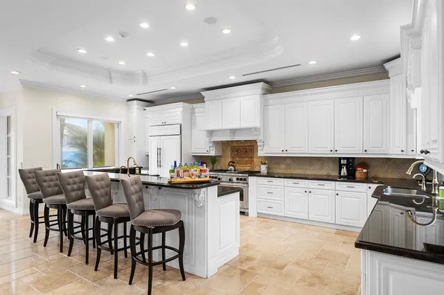 a kitchen with granite countertop a stove sink and cabinets